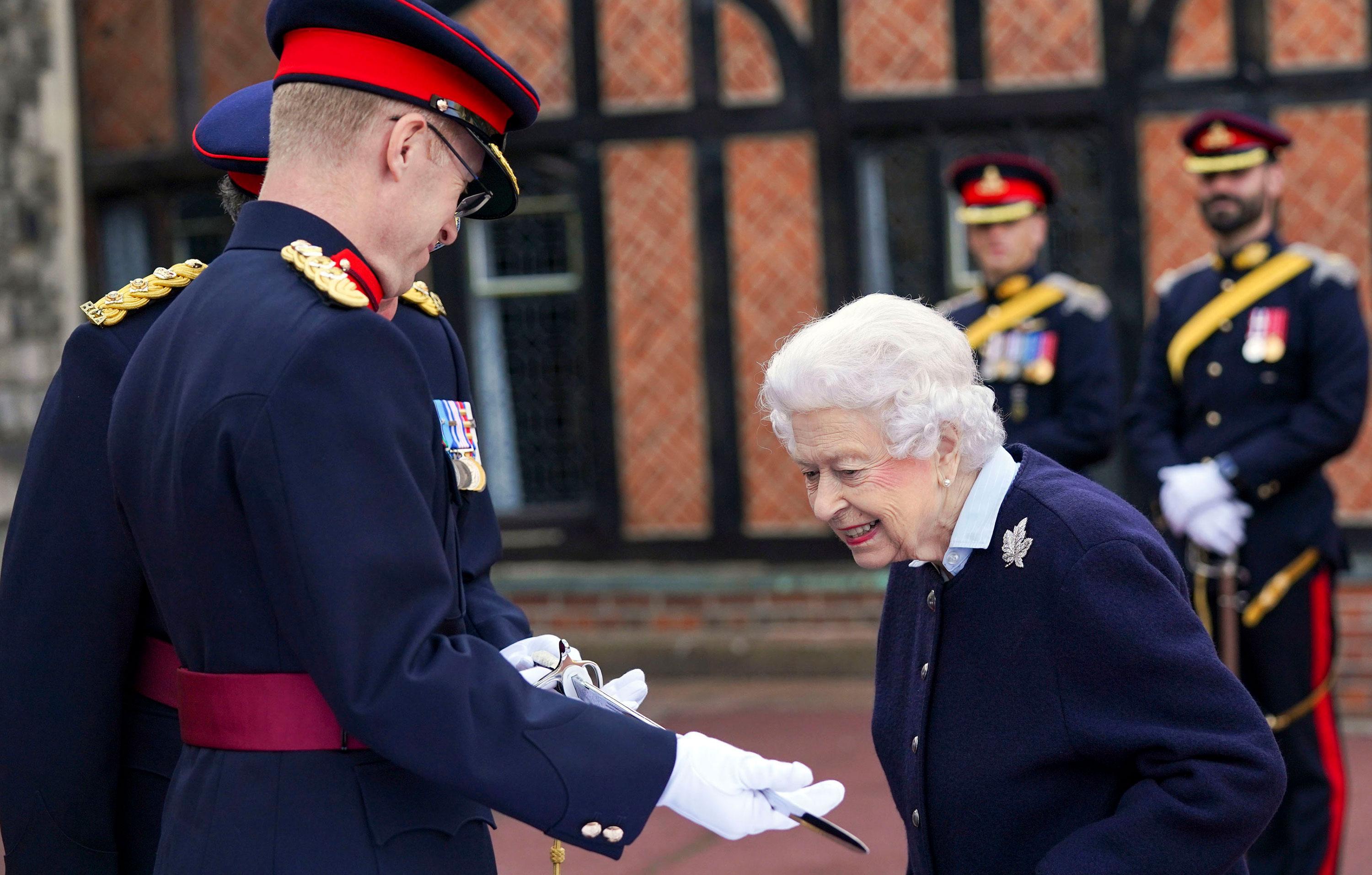 queen views commonwealth games baton and meets members royal regiment