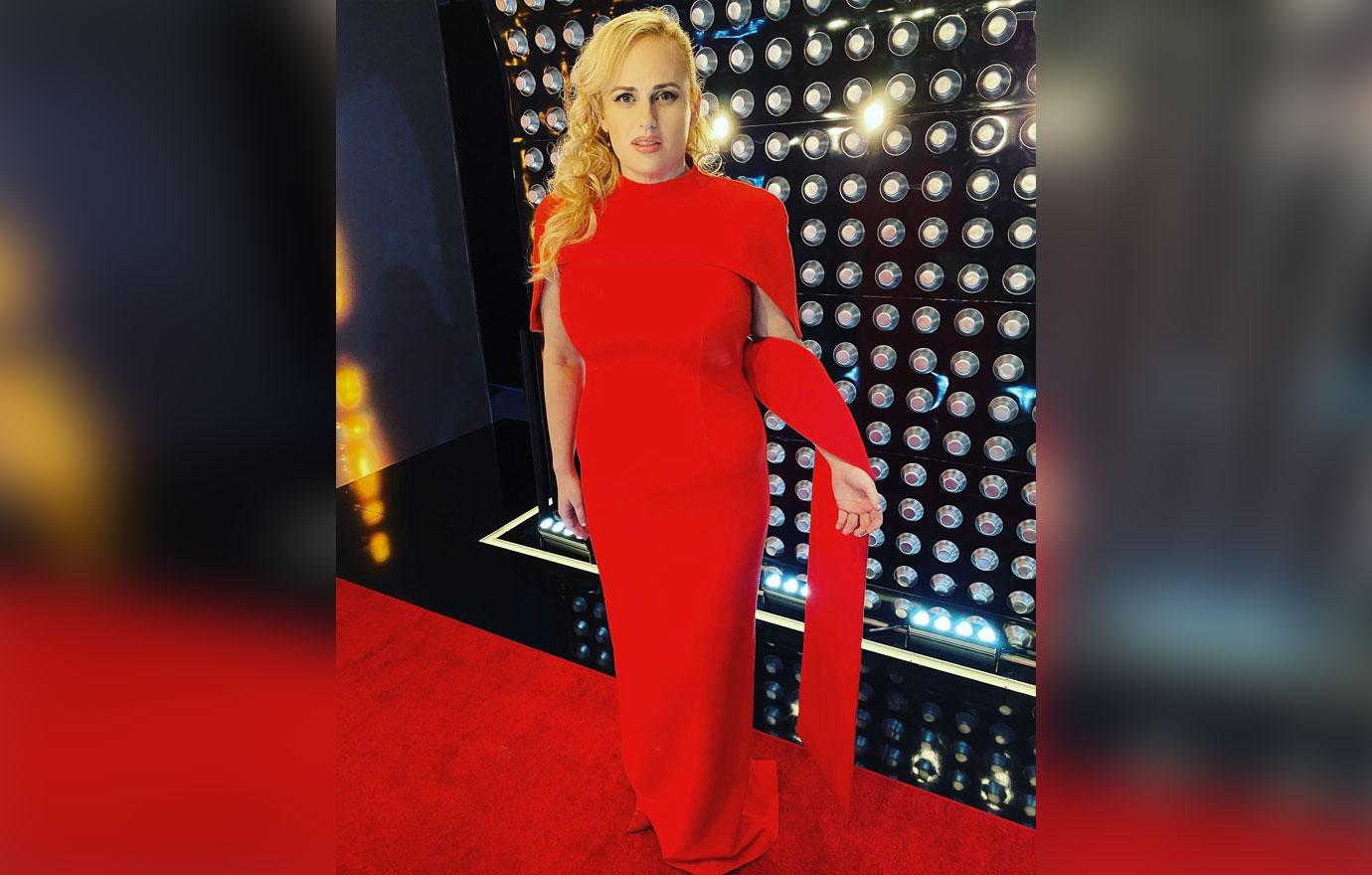 rebel wilson rocks same red gown meghan markle wore tro