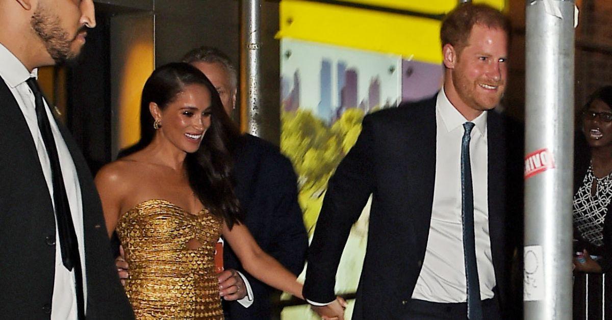 meghan markle and prince harry smiling on red carpet