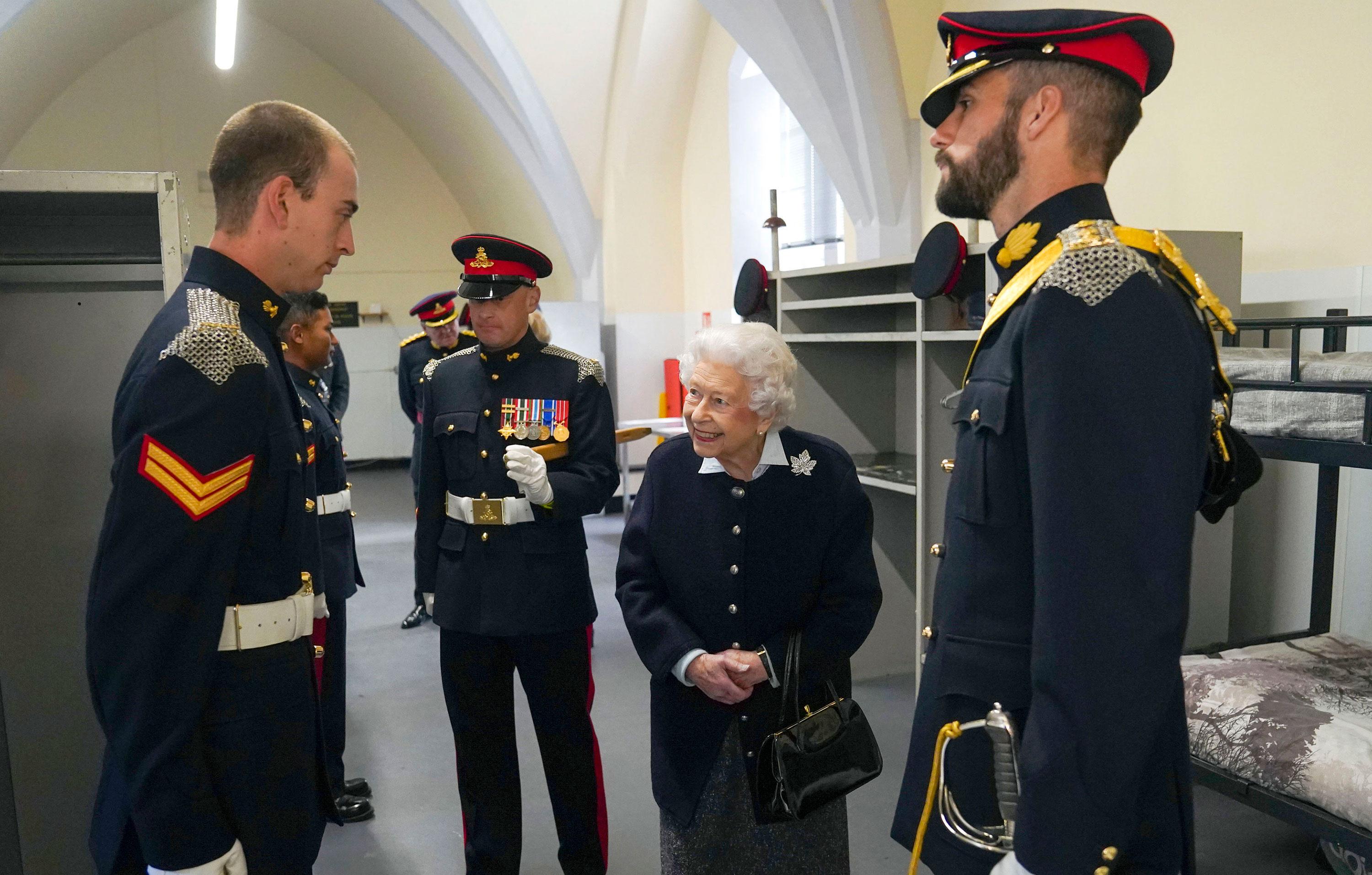 queen views commonwealth games baton and meets members royal regiment