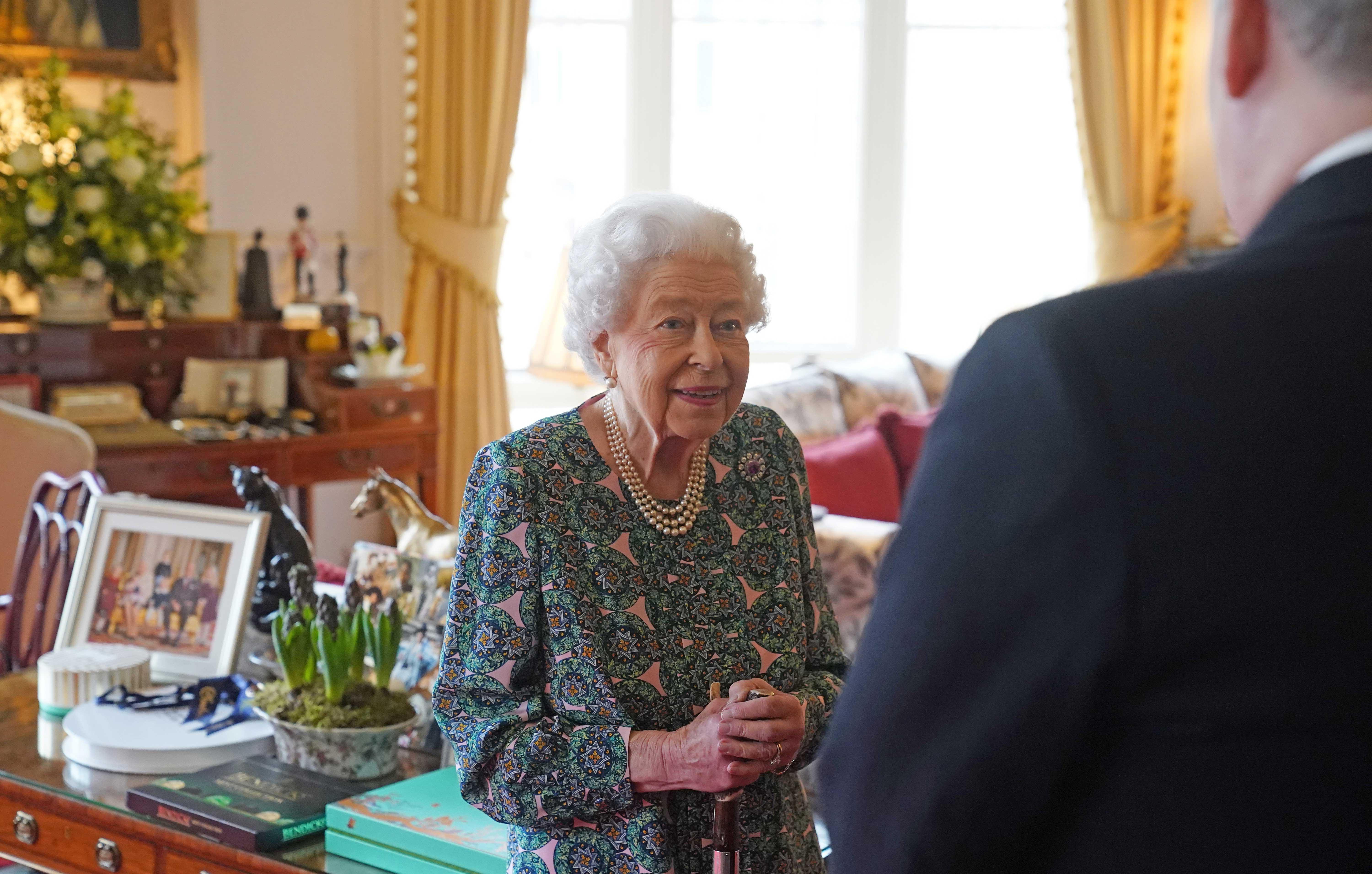 the queen conducts an audience at windsor castle